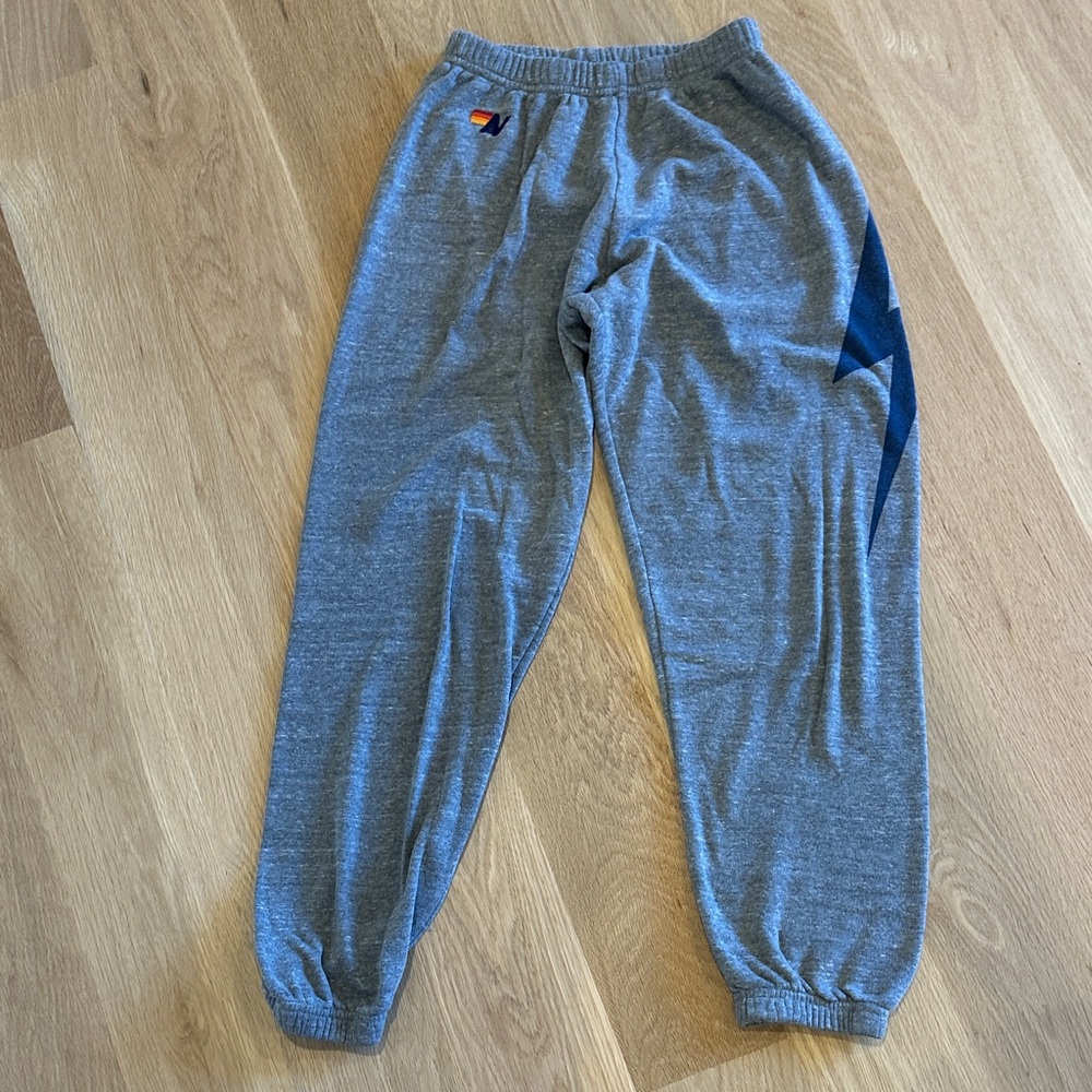 Aviator Nation Gray Sweatpants with Blue lightening bolt down leg.